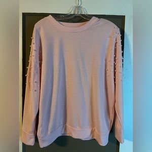 Soft pink sweater with white pearls on sleeves